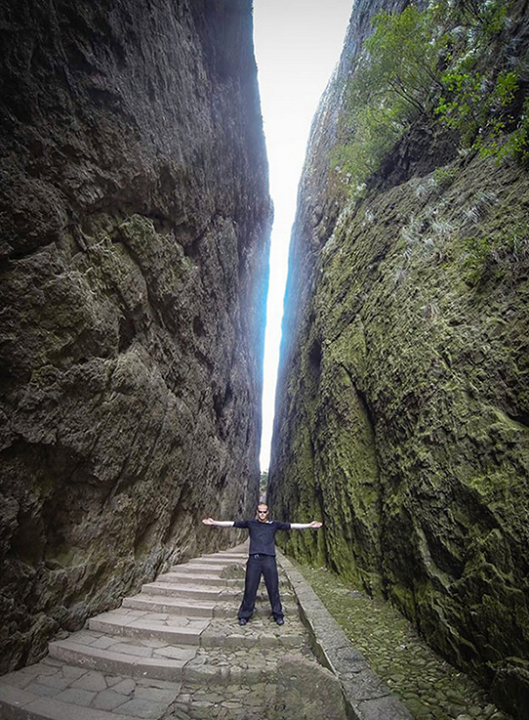 Jeb Corliss standing in the crack at Mount Jianglang *Photographer:* Courtesy of Jeb Corliss